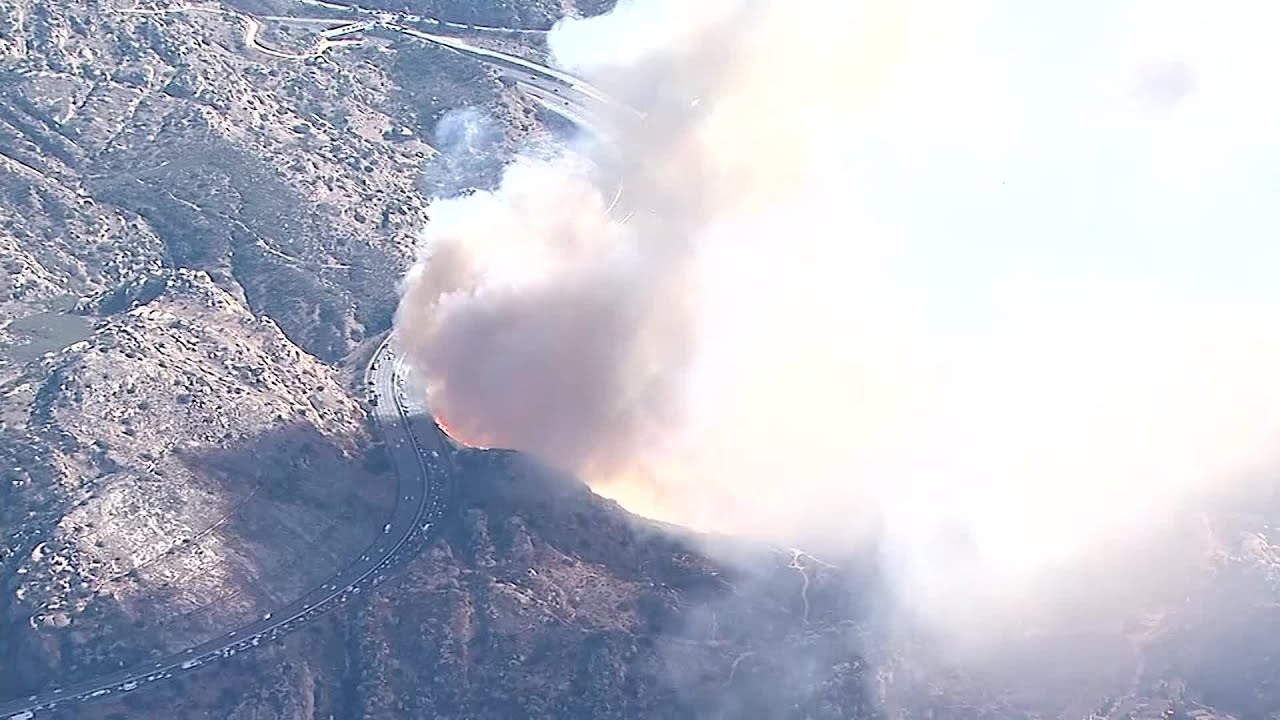 WATCH: Peak Fire flames burn close to freeway